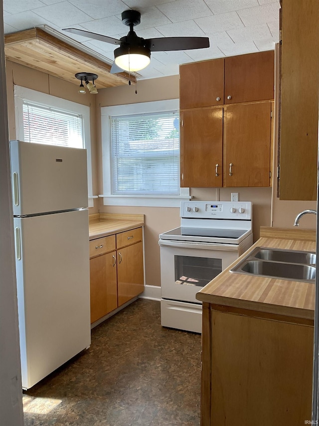 2103 Kentucky Ave, Fort Wayne, IN 46805 - kitchen featuring white appliances, a ceiling fan, and brown cabinets