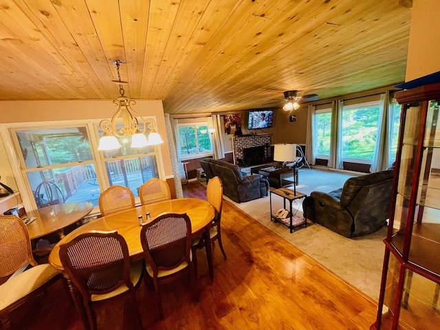 7640 Union Rd, Plymouth, IN 46563 - dining room with a chandelier, wood ceiling, a ceiling fan, a brick fireplace, and wood finished floors