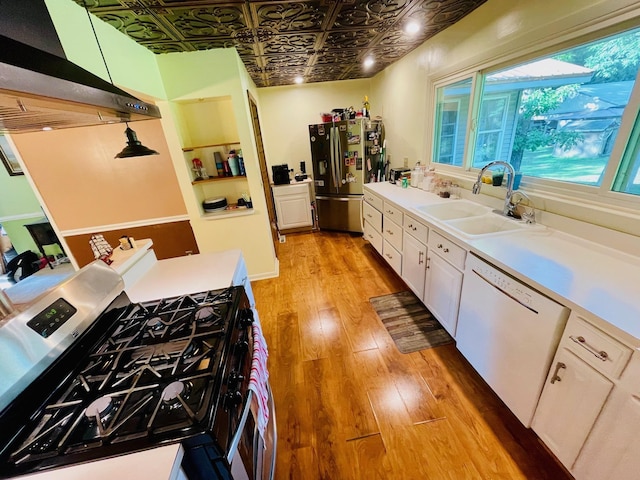 7640 Union Rd, Plymouth, IN 46563 - kitchen featuring appliances with stainless steel finishes, an ornate ceiling, light wood-style floors, ventilation hood, and white cabinets