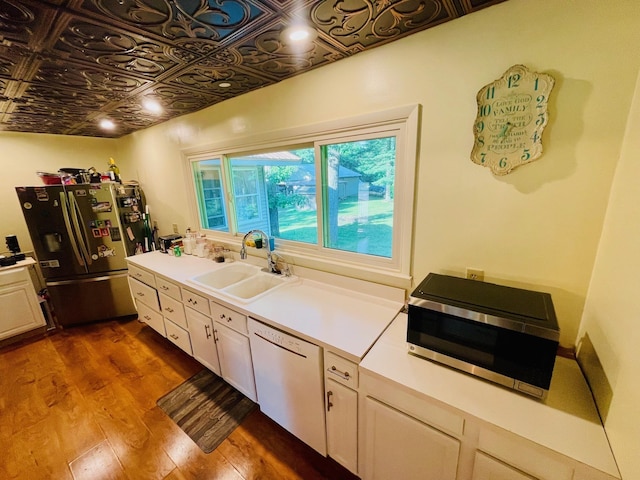 7640 Union Rd, Plymouth, IN 46563 - kitchen with appliances with stainless steel finishes, dark wood-style flooring, an ornate ceiling, white cabinets, and light countertops