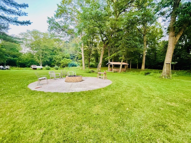 7640 Union Rd, Plymouth, IN 46563 - view of green lawn with an outdoor fire pit and a patio