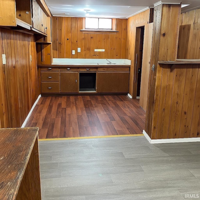 2056 Riedmiller Ave, Fort Wayne, IN 46802 - kitchen with dark wood-style floors, brown cabinetry, and wood walls