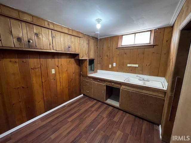 2056 Riedmiller Ave, Fort Wayne, IN 46802 - kitchen with dark wood-style floors, wood walls, and light countertops