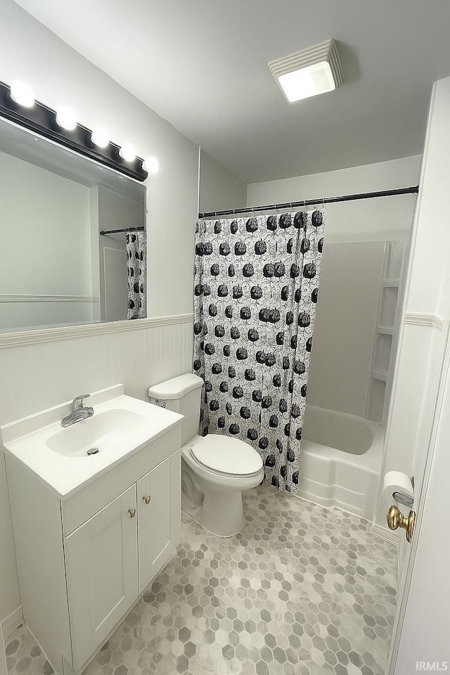 2056 Riedmiller Ave, Fort Wayne, IN 46802 - bathroom featuring vanity, wainscoting, and shower / bathtub combination with curtain