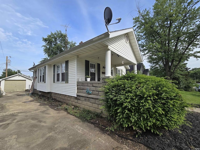 410 NW 2nd St, Washington, IN 47501 - view of property exterior featuring an outbuilding, covered porch, a garage, and driveway