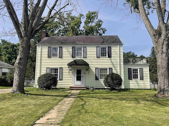 3001 S Pennsylvania Ave, Logansport, IN 46947 - colonial-style house featuring a chimney and a front yard