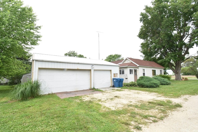 102 S Foster St, Boswell, IN 47921 - view of front of home with a detached garage, an outbuilding, and a front lawn