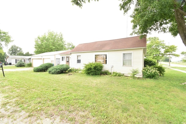 102 S Foster St, Boswell, IN 47921 - rear view of house with a lawn and a garage