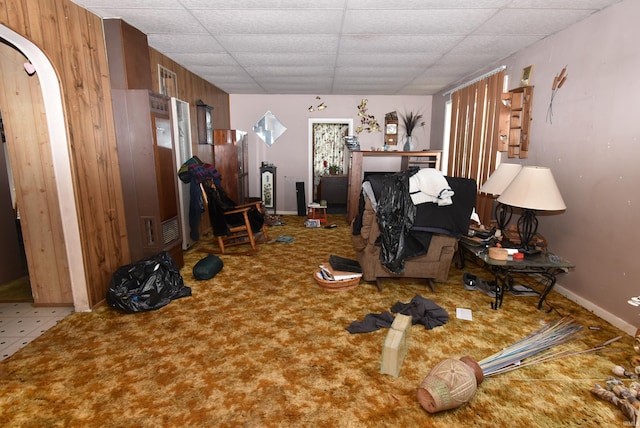 102 S Foster St, Boswell, IN 47921 - living room with carpet flooring, a paneled ceiling, arched walkways, and wooden walls
