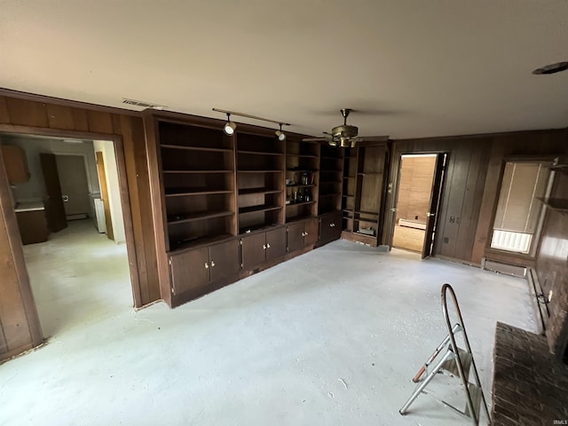 3215 Wakashan Pl, Fort Wayne, IN 46815 - unfurnished living room with concrete flooring, a ceiling fan, and wooden walls