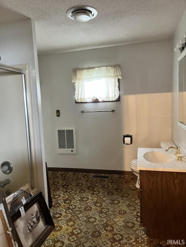 126 E Washington St, Monroe, IN 46772 - bathroom featuring heating unit, vanity, and a textured ceiling
