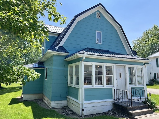 126 E Washington St, Monroe, IN 46772 - back of house featuring a metal roof, a yard, a sunroom, and a standing seam roof