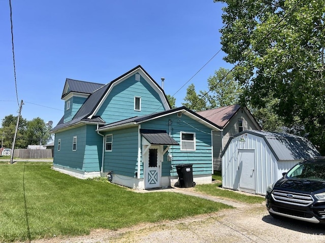 126 E Washington St, Monroe, IN 46772 - view of front of property featuring a storage unit, a metal roof, and a gambrel roof