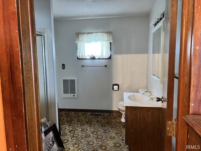 126 E Washington St, Monroe, IN 46772 - bathroom featuring vanity, a shower with shower door, a textured ceiling, and heating unit