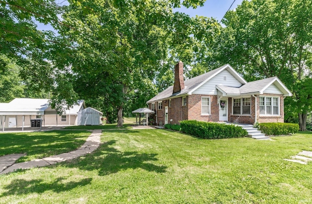 3721 Claremont Ave, Evansville, IN 47712 - view of front facade featuring a storage shed, a chimney, a front yard, and brick siding