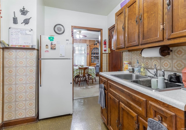 3721 Claremont Ave, Evansville, IN 47712 - kitchen featuring freestanding refrigerator, a ceiling fan, and brown cabinets
