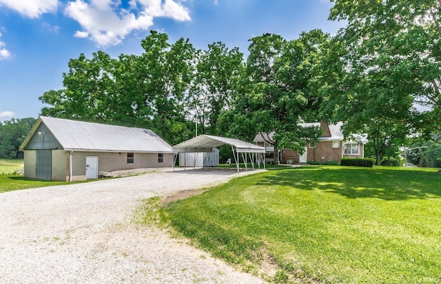 3721 Claremont Ave, Evansville, IN 47712 - ranch-style home featuring gravel driveway, a carport, a front lawn, and an outdoor structure