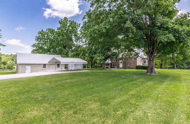 3721 Claremont Ave, Evansville, IN 47712 - view of green lawn with a carport, driveway, and view of scattered trees