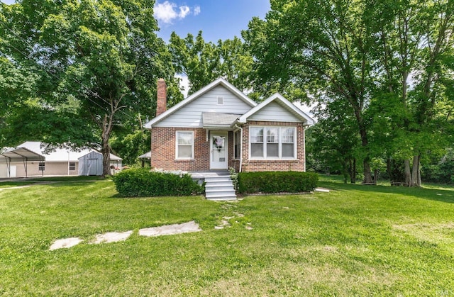 3721 Claremont Ave, Evansville, IN 47712 - bungalow-style house featuring brick siding, a chimney, and a front yard