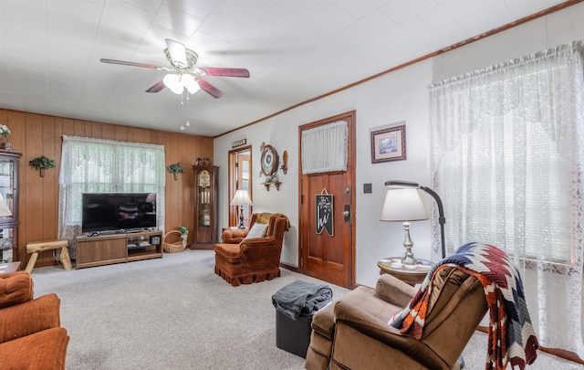 3721 Claremont Ave, Evansville, IN 47712 - carpeted living room featuring a ceiling fan, wood walls, and crown molding