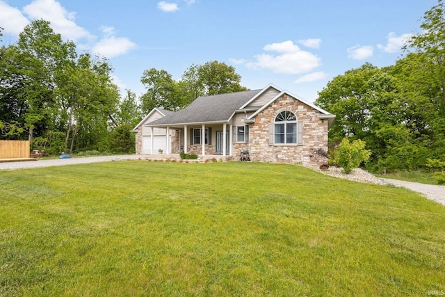 26973 Water Edge Dr, Elkhart, IN 46514 - ranch-style house with driveway, stone siding, a garage, a front lawn, and a porch