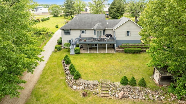 26973 Water Edge Dr, Elkhart, IN 46514 - back of house with stairway, a wooden deck, and a lawn
