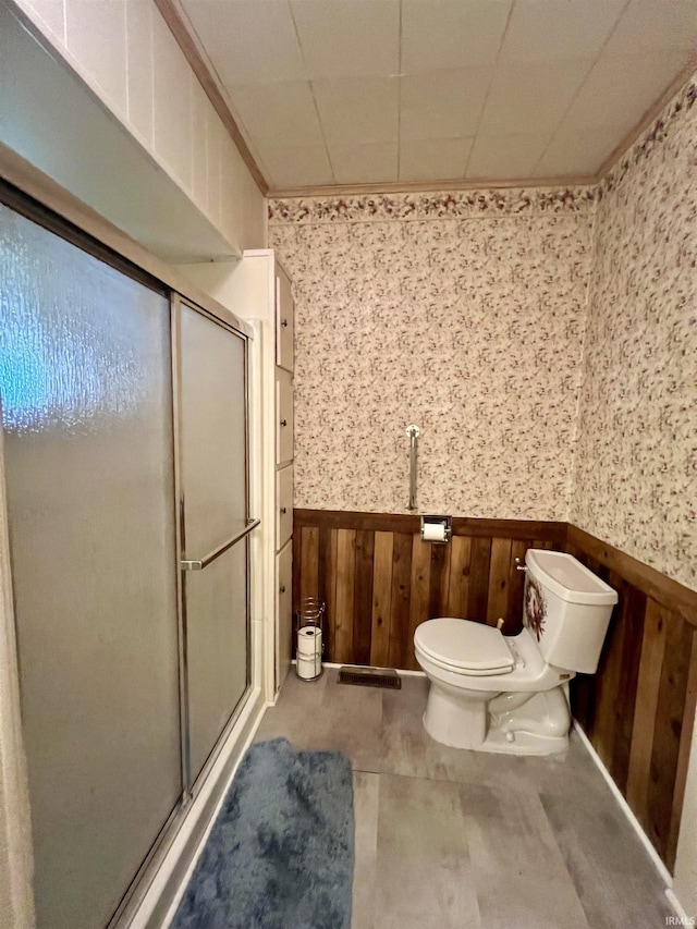 323 Simon St, Plymouth, IN 46563 - bathroom with a wainscoted wall, wooden walls, a stall shower, and wallpapered walls