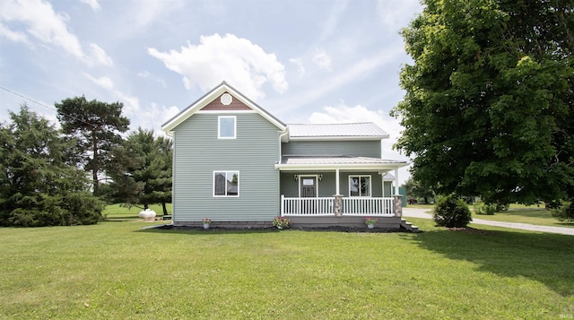3046 Long Lake Rd, Albion, IN 46701 - rear view of property with covered porch, a lawn, and a metal roof