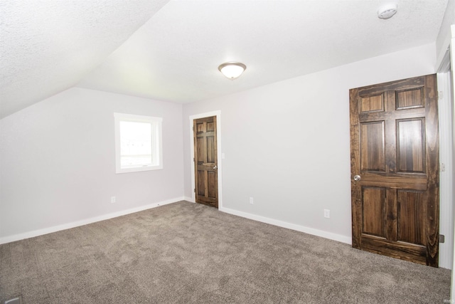 3046 Long Lake Rd, Albion, IN 46701 - unfurnished bedroom with carpet flooring, vaulted ceiling, and a textured ceiling