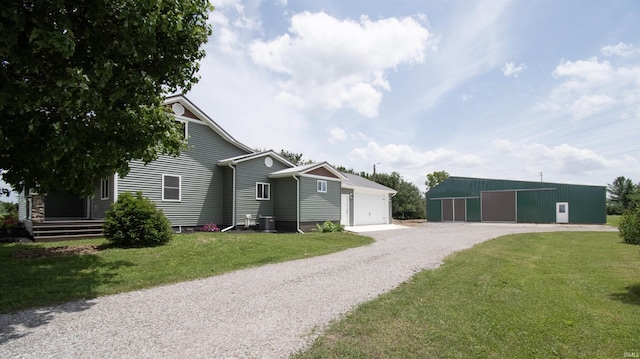 3046 Long Lake Rd, Albion, IN 46701 - view of front facade featuring a front lawn, gravel driveway, an outdoor structure, a pole building, and a garage