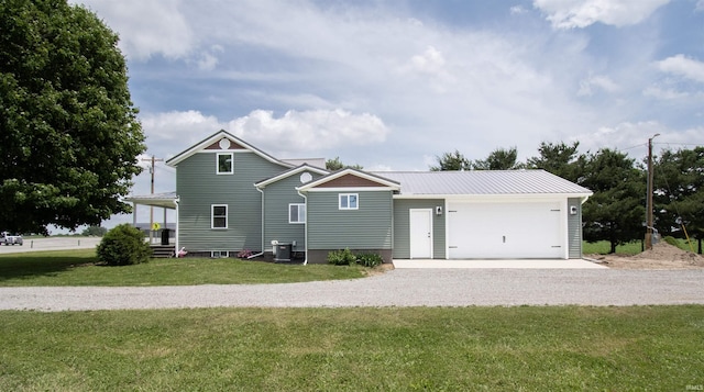 3046 Long Lake Rd, Albion, IN 46701 - view of front of property featuring gravel driveway, a front yard, a garage, and a metal roof