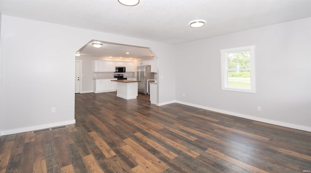 3046 Long Lake Rd, Albion, IN 46701 - unfurnished living room featuring arched walkways and dark wood finished floors