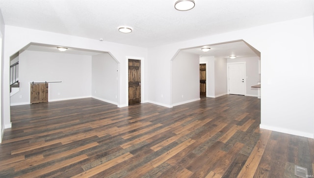 3046 Long Lake Rd, Albion, IN 46701 - unfurnished living room featuring arched walkways and wood finished floors