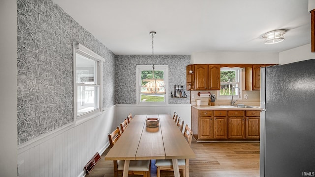1897 Lakeshore Dr, Walkerton, IN 46574 - dining area with plenty of natural light, wainscoting, light wood-style flooring, and wallpapered walls