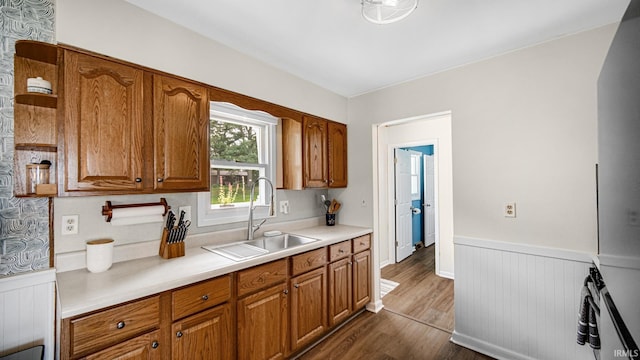 1897 Lakeshore Dr, Walkerton, IN 46574 - kitchen featuring dark wood-type flooring, a wainscoted wall, brown cabinets, and light countertops