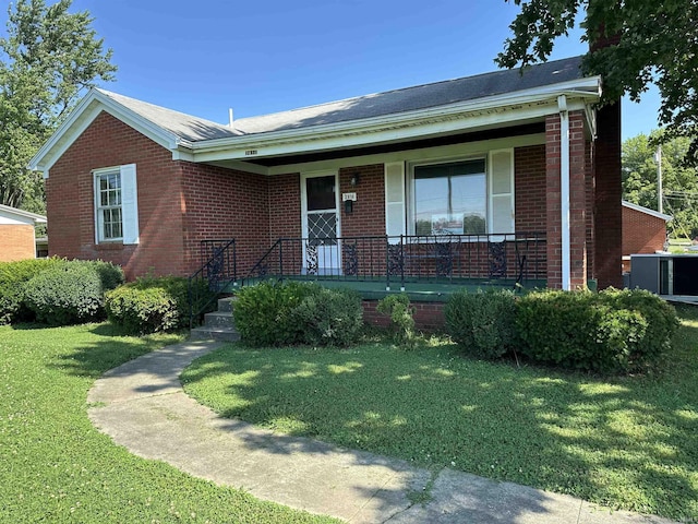 2816 E Morgan Ave, Evansville, IN 47711 - ranch-style house featuring brick siding, a front yard, and a porch