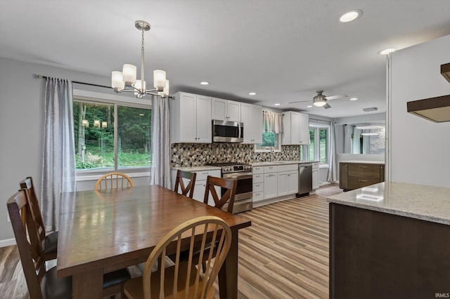 953 Handlebar Rd, Mishawaka, IN 46544 - dining room with light wood-type flooring, a chandelier, recessed lighting, and a ceiling fan