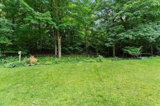 953 Handlebar Rd, Mishawaka, IN 46544 - view of grassy yard with a wooded view