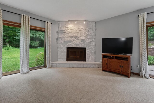 953 Handlebar Rd, Mishawaka, IN 46544 - unfurnished living room featuring track lighting, carpet, and a fireplace