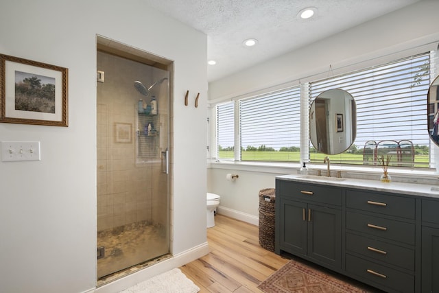 3865 E Forest Glen Ave, Leesburg, IN 46538 - bathroom with a stall shower, vanity, wood finished floors, recessed lighting, and a textured ceiling