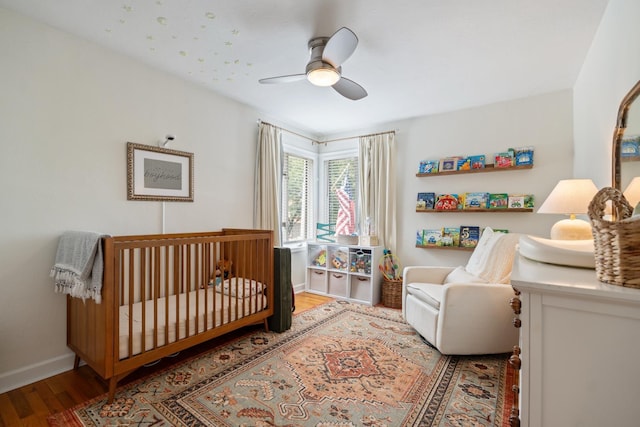 3865 E Forest Glen Ave, Leesburg, IN 46538 - bedroom with wood finished floors, a crib, and ceiling fan