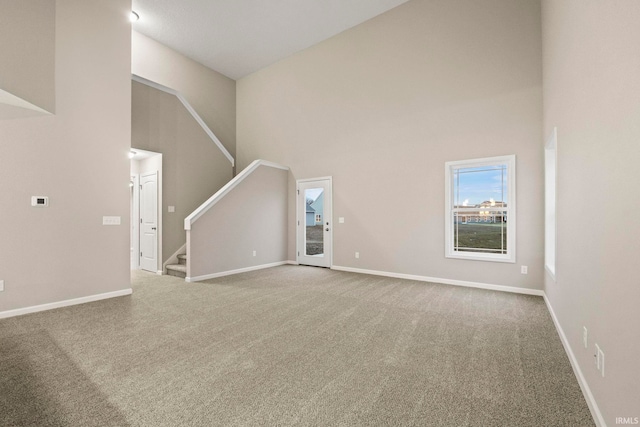 10263 Tirian Pl, Fort Wayne, IN 46835 - unfurnished living room featuring stairway, carpet flooring, and a high ceiling