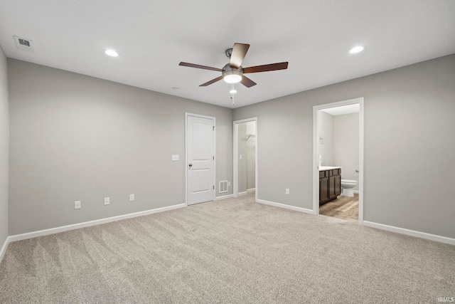 10263 Tirian Pl, Fort Wayne, IN 46835 - unfurnished bedroom featuring light colored carpet, connected bathroom, a walk in closet, recessed lighting, and a ceiling fan