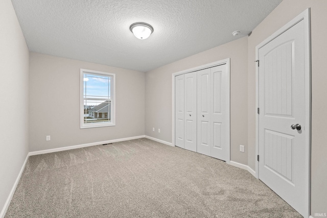 10263 Tirian Pl, Fort Wayne, IN 46835 - unfurnished bedroom featuring a textured ceiling, carpet floors, and a closet