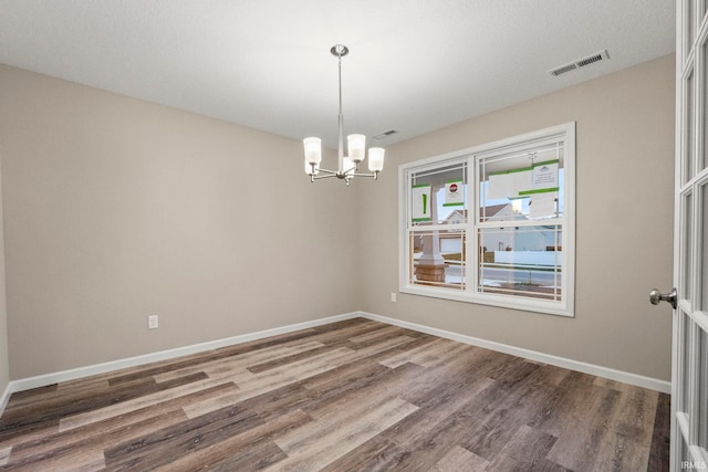 10263 Tirian Pl, Fort Wayne, IN 46835 - unfurnished room featuring wood finished floors and a chandelier