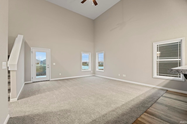 10263 Tirian Pl, Fort Wayne, IN 46835 - spare room featuring a towering ceiling, a ceiling fan, plenty of natural light, and wood finished floors