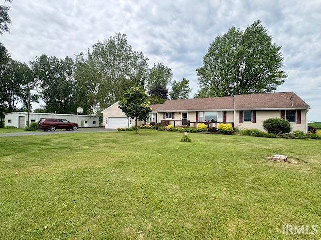 7737 N 100 E Rd, Lucerne, IN 46950 - ranch-style home featuring a front yard and a detached garage