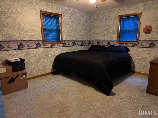 7737 N 100 E Rd, Lucerne, IN 46950 - bedroom with wallpapered walls, carpet, ceiling fan, and a wainscoted wall
