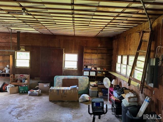 7737 N 100 E Rd, Lucerne, IN 46950 - misc room featuring unfinished concrete floors, wooden walls, and healthy amount of natural light
