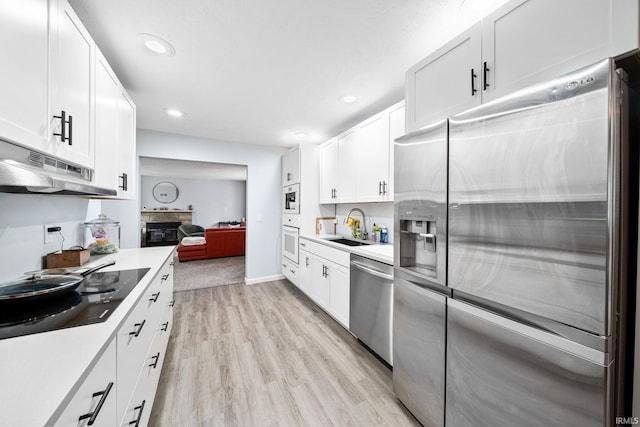 241 Sylvan Glen Dr, South Bend, IN 46615 - kitchen featuring stainless steel appliances, recessed lighting, light wood-type flooring, light countertops, and white cabinetry